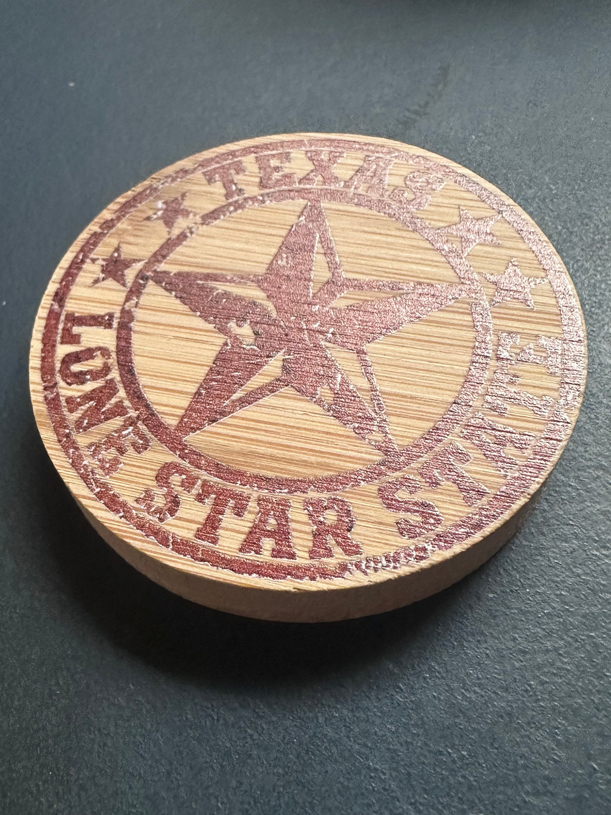 Bamboo magnetic bottle opener laser engraved with Texas Lone Star State design, angled view